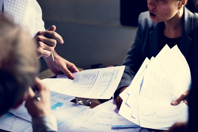 Two team members reviewing a payment approval together to prevent wire transfer fraud